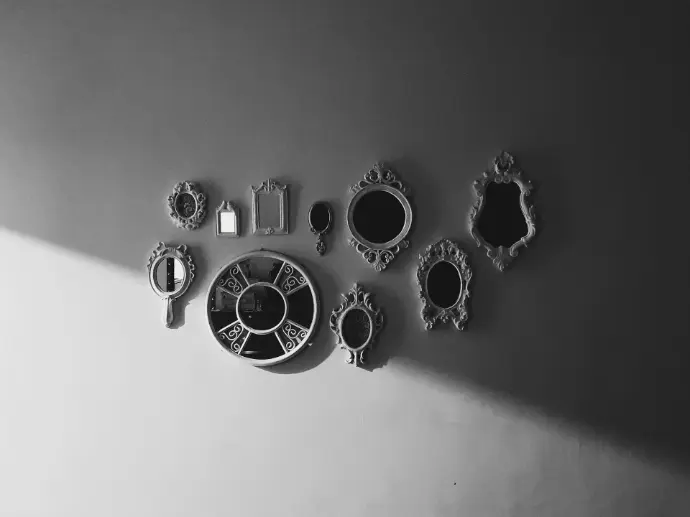 a black and white photo of a wall clock